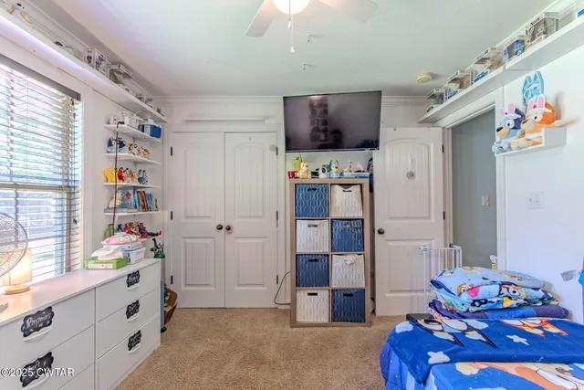 a room with furniture a flat screen tv and a window