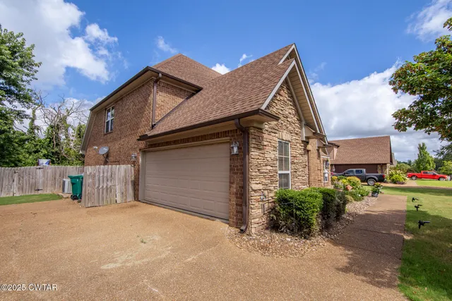 a view of a house with a yard and garage