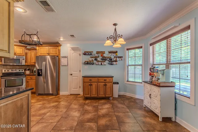 a kitchen with stainless steel appliances granite countertop a refrigerator and a stove top oven