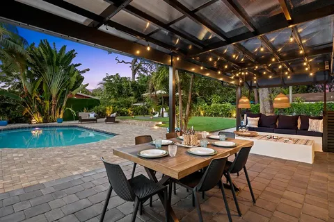 a view of a patio with a table and chairs and potted plants