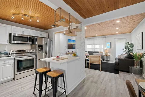 a kitchen with stainless steel appliances a stove sink microwave and cabinets