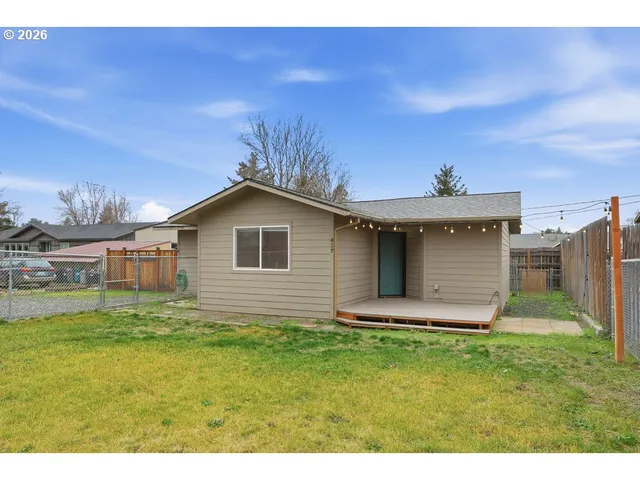 a view of a backyard with wooden fence