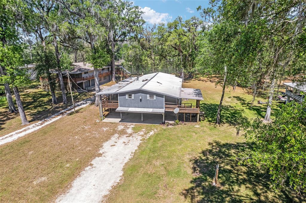 7870 Southwest 25th Place Bell, FL 32619 - Photo 2 of 99 a view of a house with a yard and sitting area