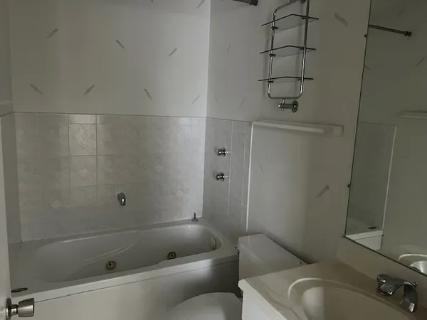 a bathroom with a toilet and shower