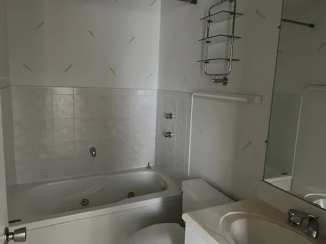 a bathroom with a toilet and shower
