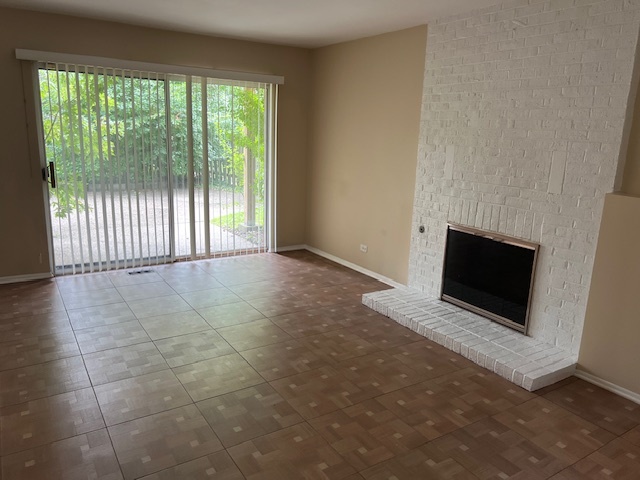 107 Horatio Boulevard Buffalo Grove, IL 60089 - Photo 15 of 27 a view of an empty room with a fireplace and a window