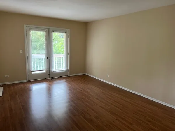a view of a room with wooden floor and window