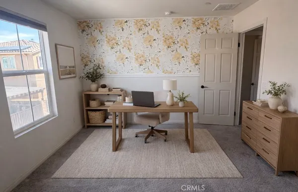 a workspace with lounge chair and a window