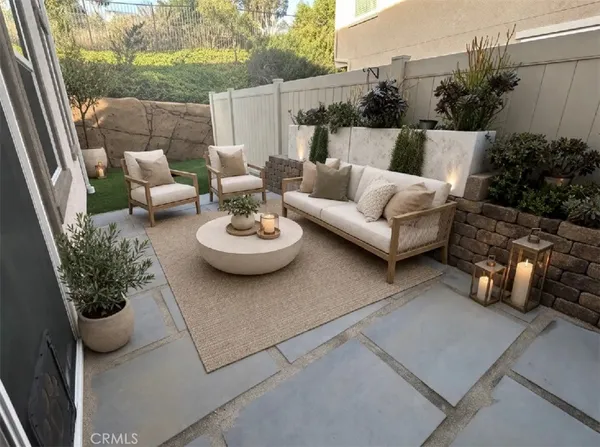 a view of a patio with couches and potted plants