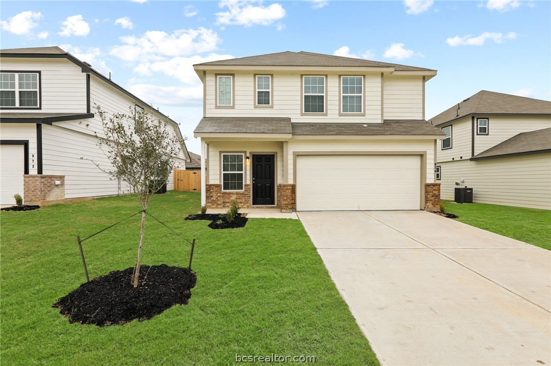 970 Harper Lane Bryan, TX 77803 - Photo 1 of 1 a front view of a house with a yard and garage
