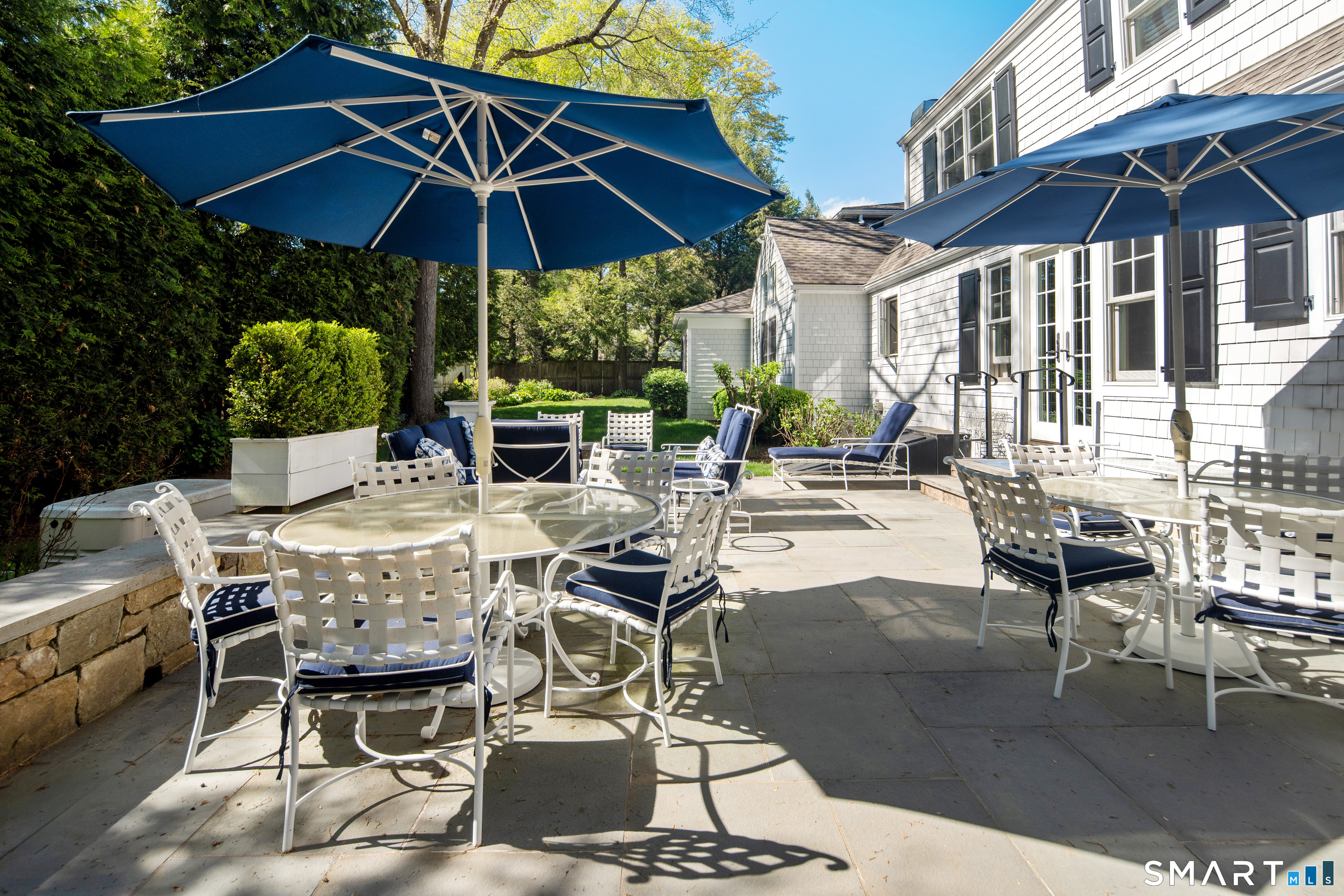 11 McLaren Road South Darien, CT 06820 - Photo 17 of 40 a patio with a patio table and chairs