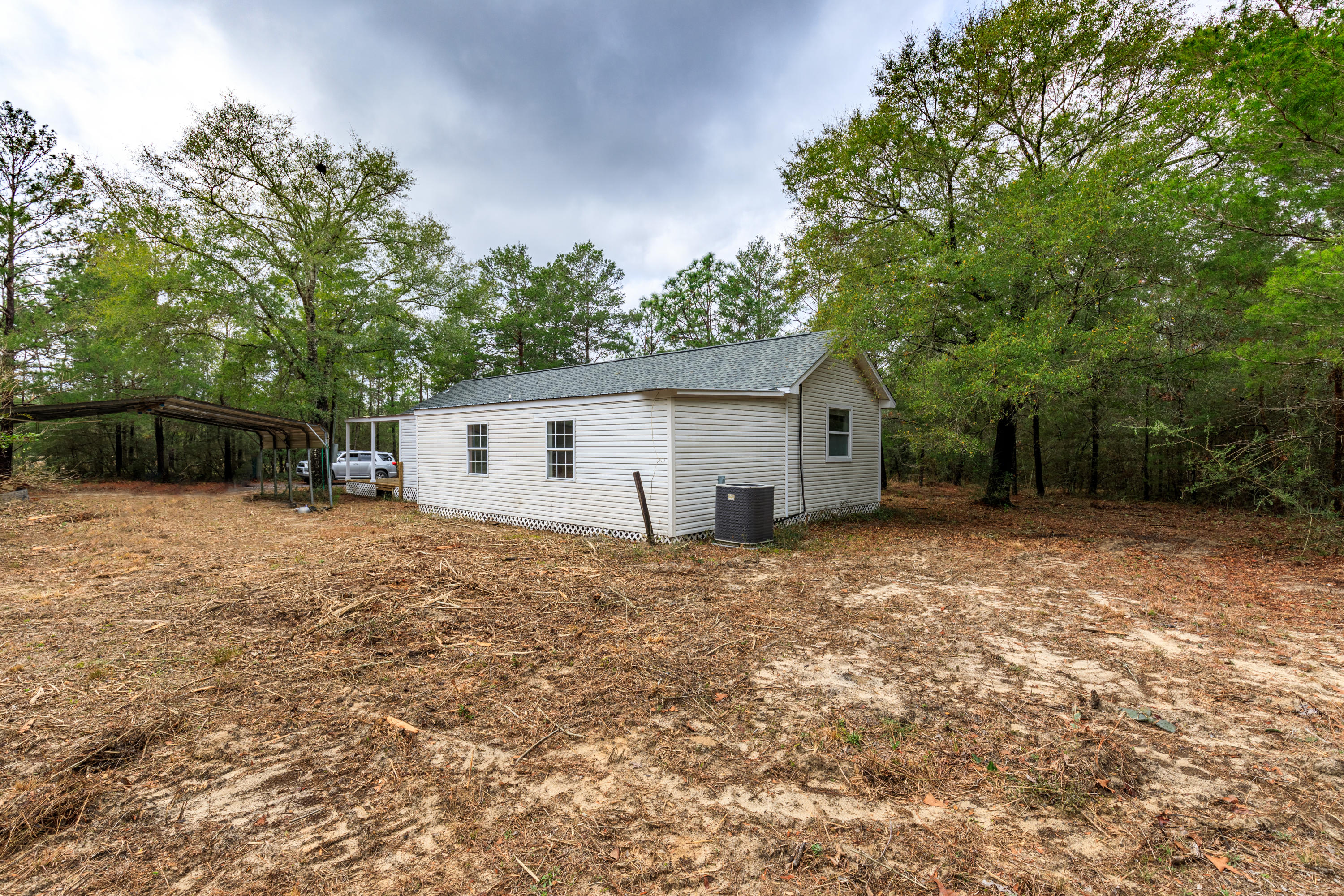 1504 Hinote Road DeFuniak Springs, FL 32433 - Photo 20 of 21 a view of a house with a yard and garage
