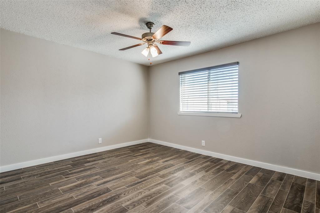 2211 West Hickory Street, Unit A2 Denton, TX 76201 - Photo 11 of 14 wooden floor in an empty room with a window