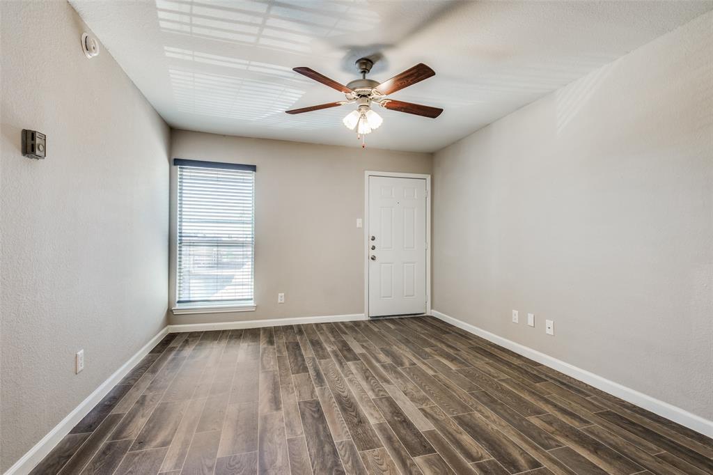 2211 West Hickory Street, Unit A2 Denton, TX 76201 - Photo 10 of 14 wooden floor in an empty room with a window