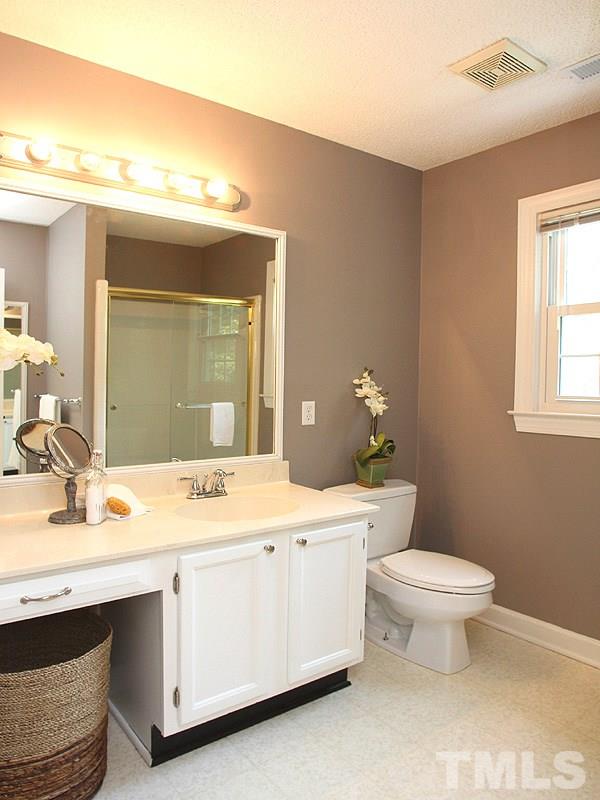 4 Swallows Ridge Court Durham, NC 27713 - Photo 12 of 18 a bathroom with a sink toilet and window
