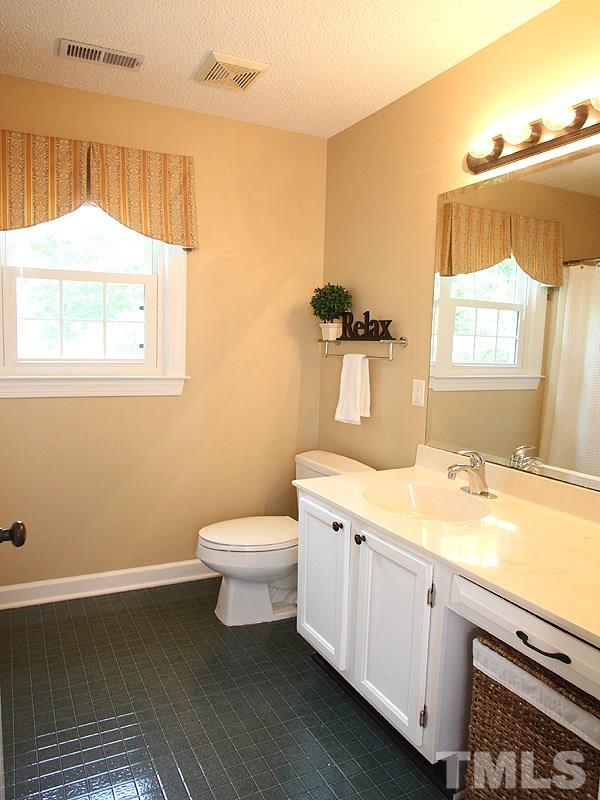 4 Swallows Ridge Court Durham, NC 27713 - Photo 14 of 18 a bathroom with a sink toilet and window