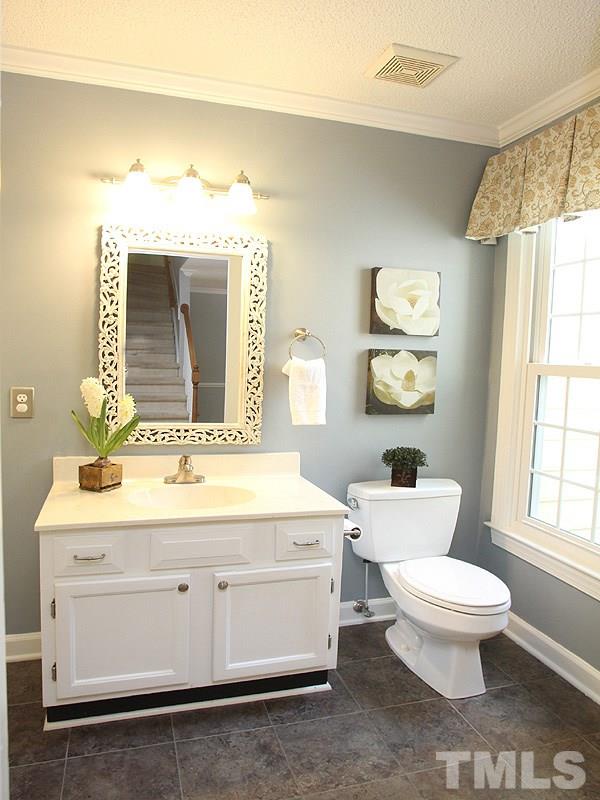4 Swallows Ridge Court Durham, NC 27713 - Photo 8 of 18 a bathroom with a toilet sink and mirror