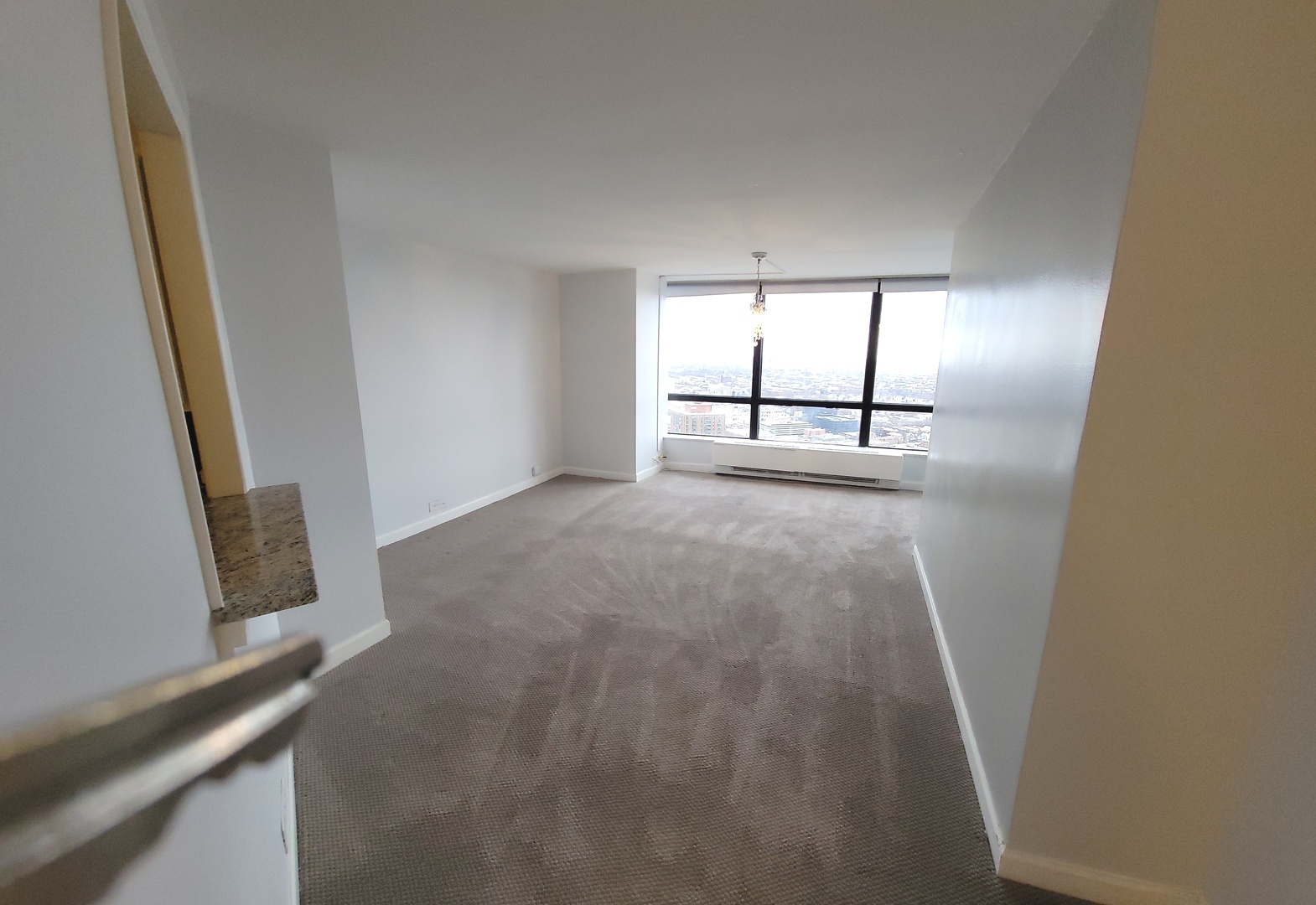 5415 North Sheridan Road, Unit 4503 Chicago, IL 60640 - Photo 7 of 19 an empty room with windows