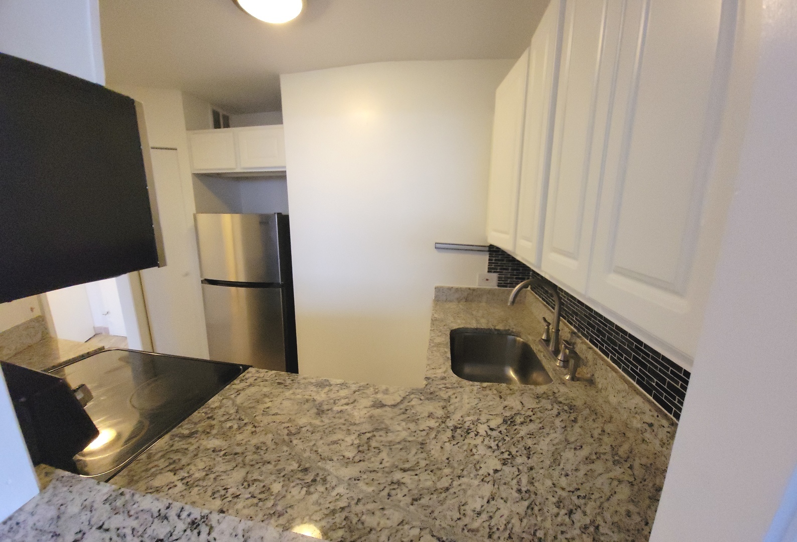 5415 North Sheridan Road, Unit 4503 Chicago, IL 60640 - Photo 9 of 19 a bedroom with a bed and a refrigerator