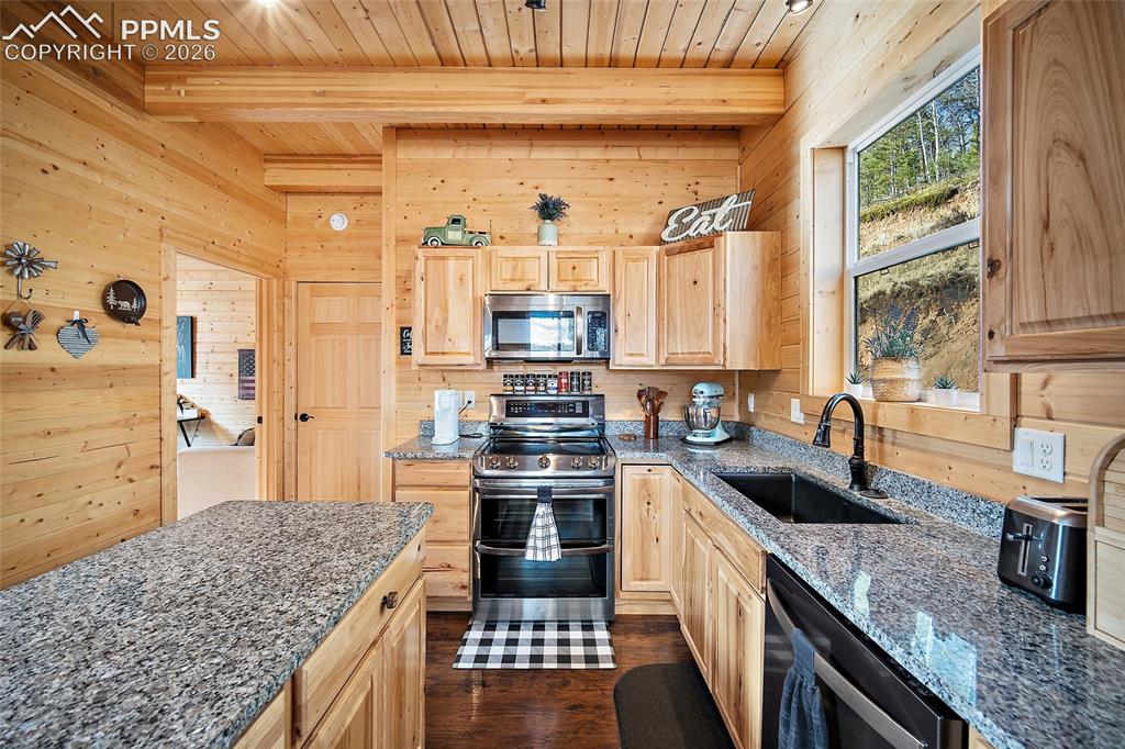 213 Willow Road Divide, CO 80814 - Photo 13 of 49 a kitchen with a stove and a sink