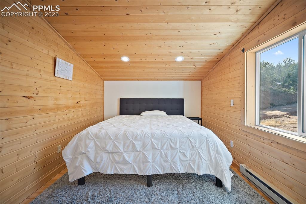 213 Willow Road Divide, CO 80814 - Photo 21 of 49 a large bed sitting in a bedroom next to a window