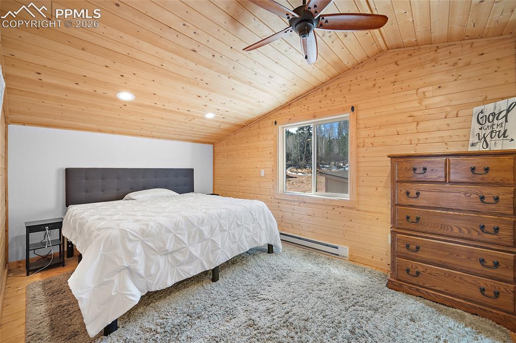 213 Willow Road Divide, CO 80814 - Photo 22 of 49 a bedroom with a bed and a mirror