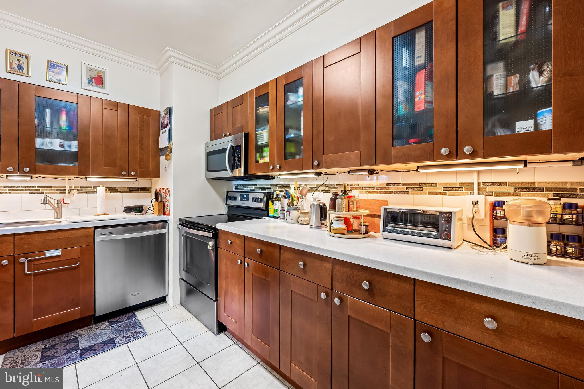 3601 Greenway, Unit 705 Baltimore, MD 21218 - Photo 12 of 30 a kitchen with stainless steel appliances granite countertop a sink stove and cabinets