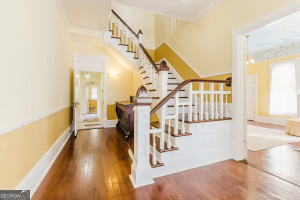 a view of entryway and hall with wooden floor