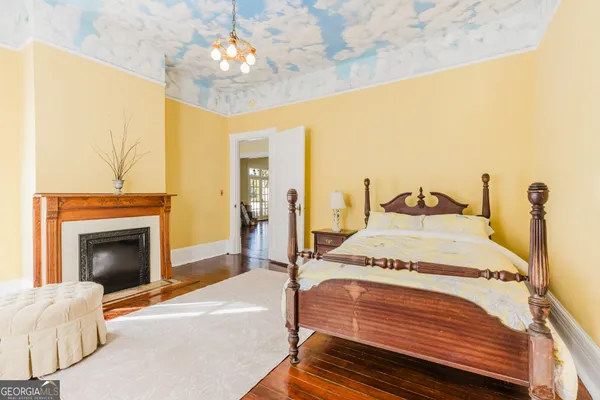 a bedroom with a bed and a fireplace