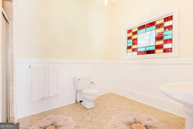 a bathroom with a toilet and a shower curtain