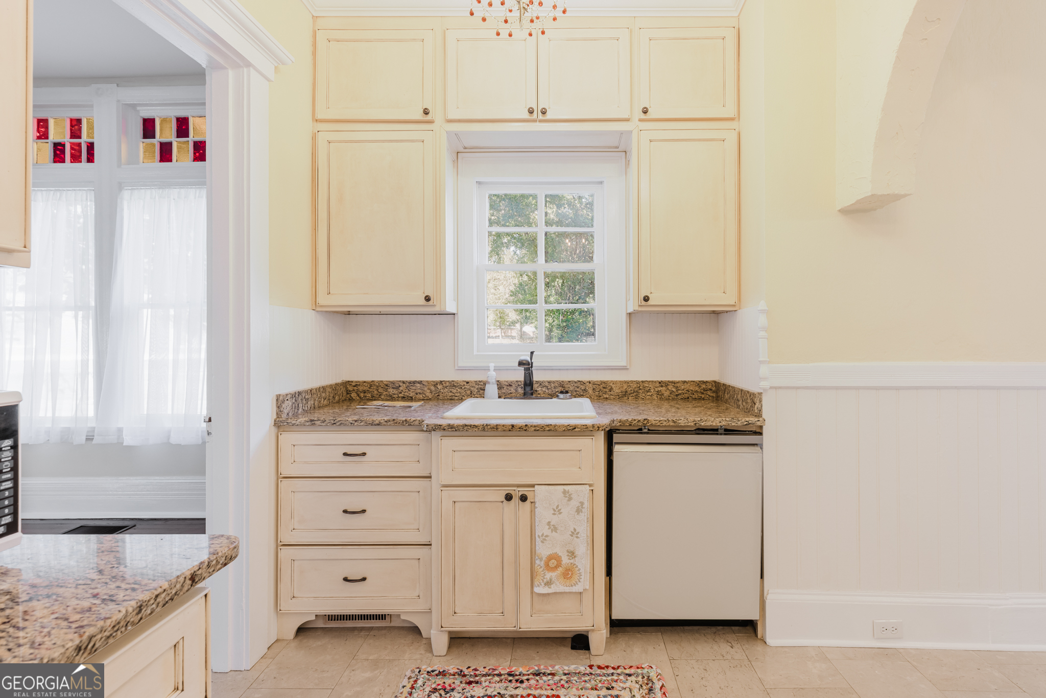 1202 South Lee Street Americus, GA 31709 - Photo 22 of 54 a kitchen with granite countertop white cabinets and white appliances