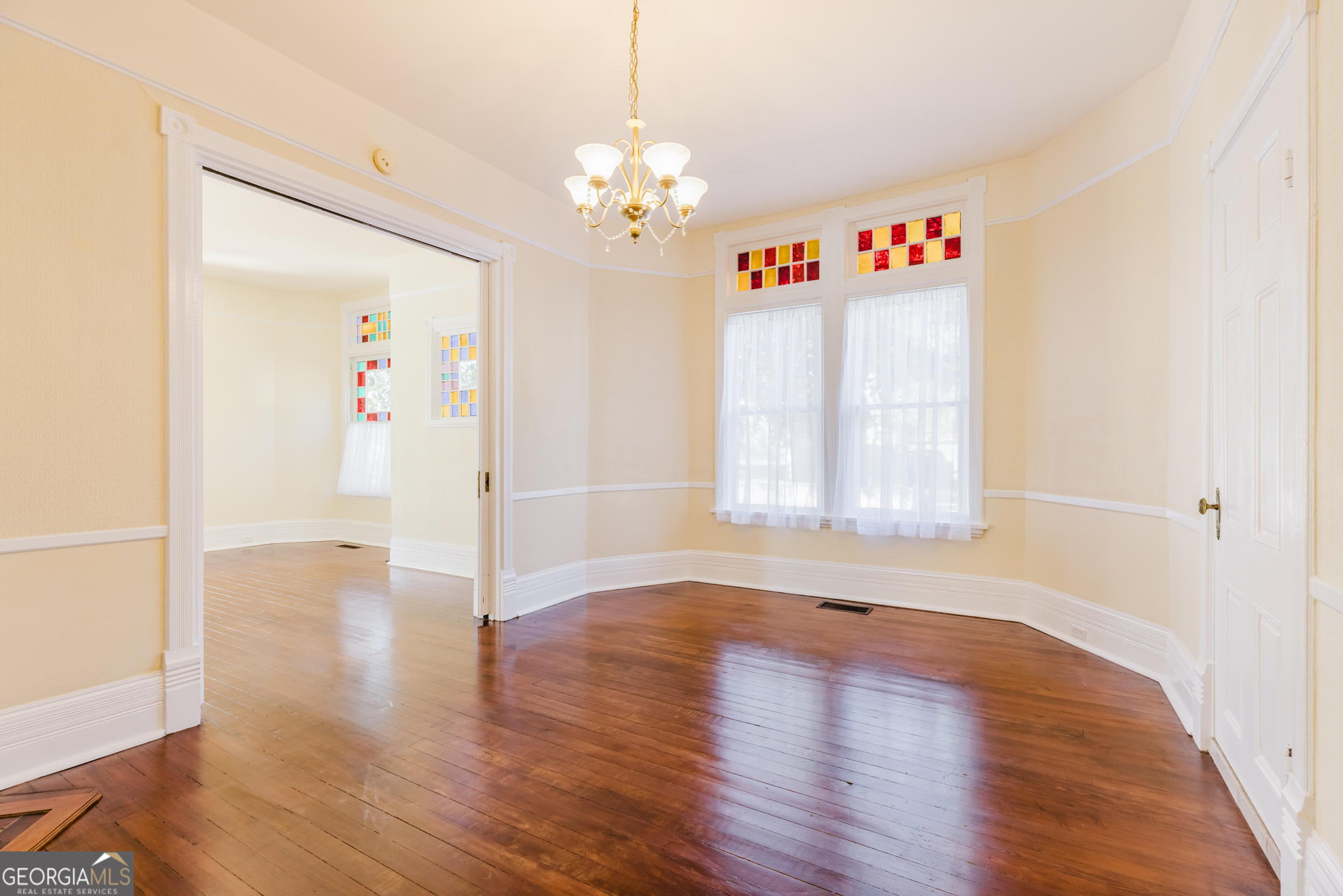 1202 South Lee Street Americus, GA 31709 - Photo 25 of 54 a view of an empty room with wooden floor and a window
