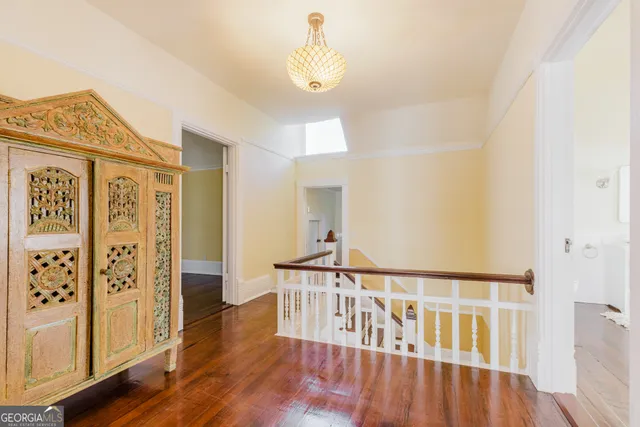 a view of a livingroom with wooden floor and a fireplace