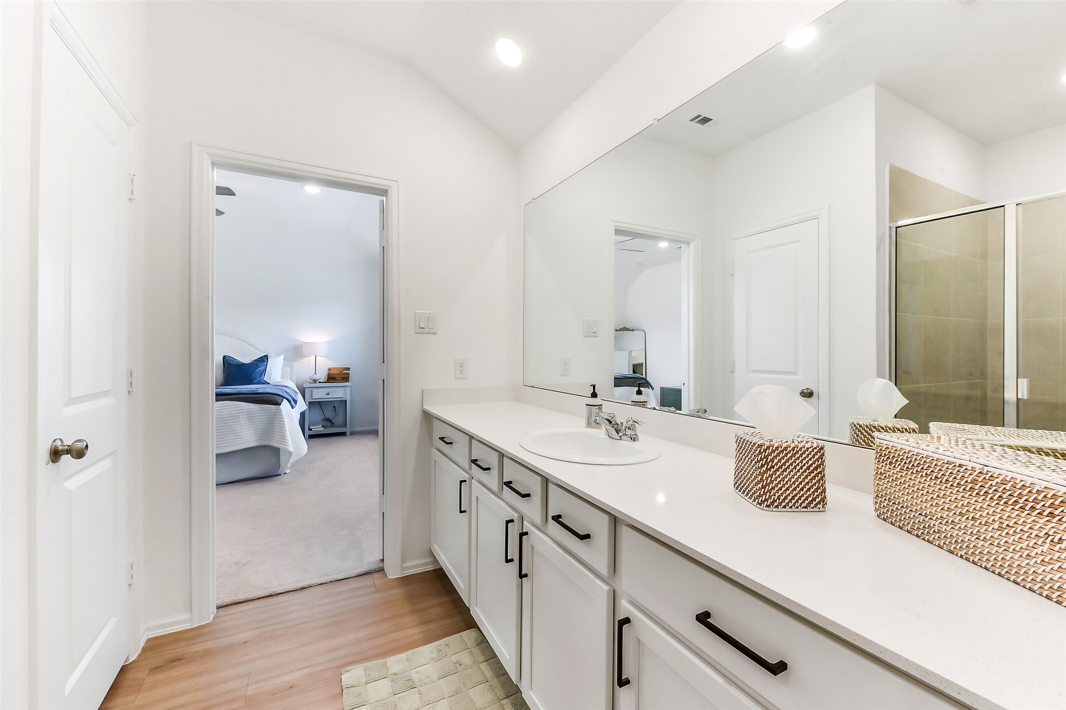3003 Marble Rise Trail Kingwood, TX 77365 - Photo 19 of 25 a spacious en suite bathroom with a double vanity sink and mirror