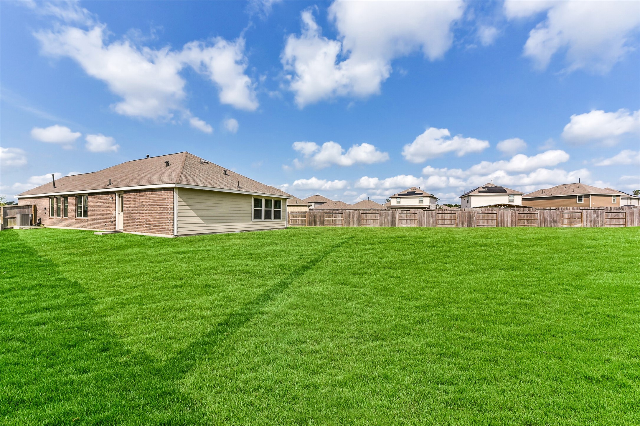 3003 Marble Rise Trail Kingwood, TX 77365 - Photo 22 of 25 a view of a house with a big yard next to a yard
