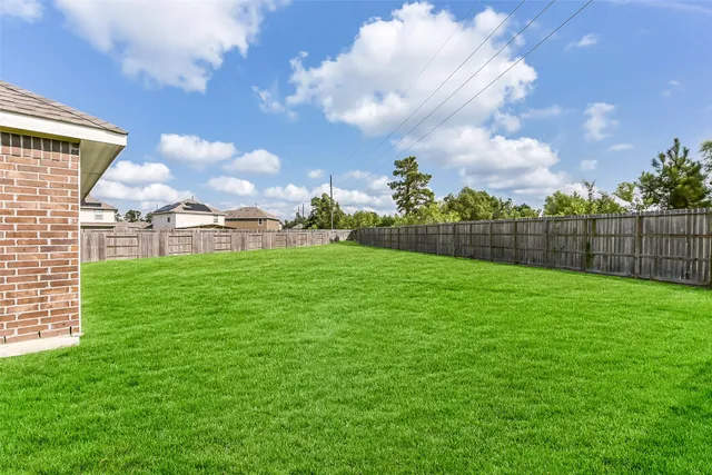 a view of a house with a big yard next to a yard