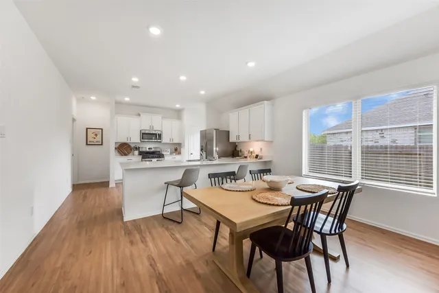 a view of a dining room with furniture window and wooden floor