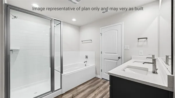 a bathroom with a bathtub a shower a sink and a mirror