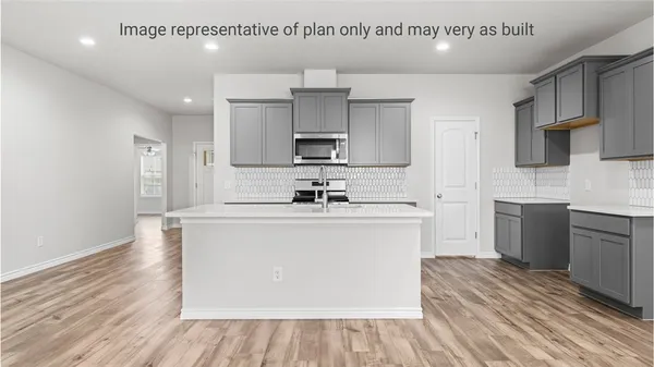 a kitchen with cabinets wooden floor and a sink