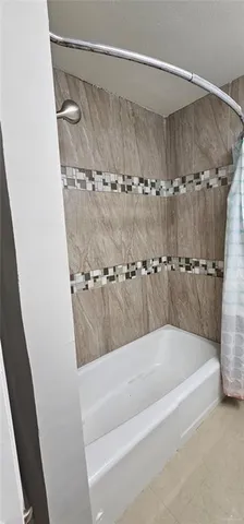 a bath tub sitting next to a shower