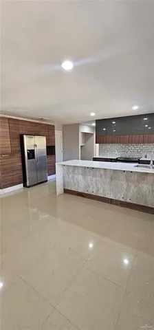 a view of a kitchen with a sink and cabinets