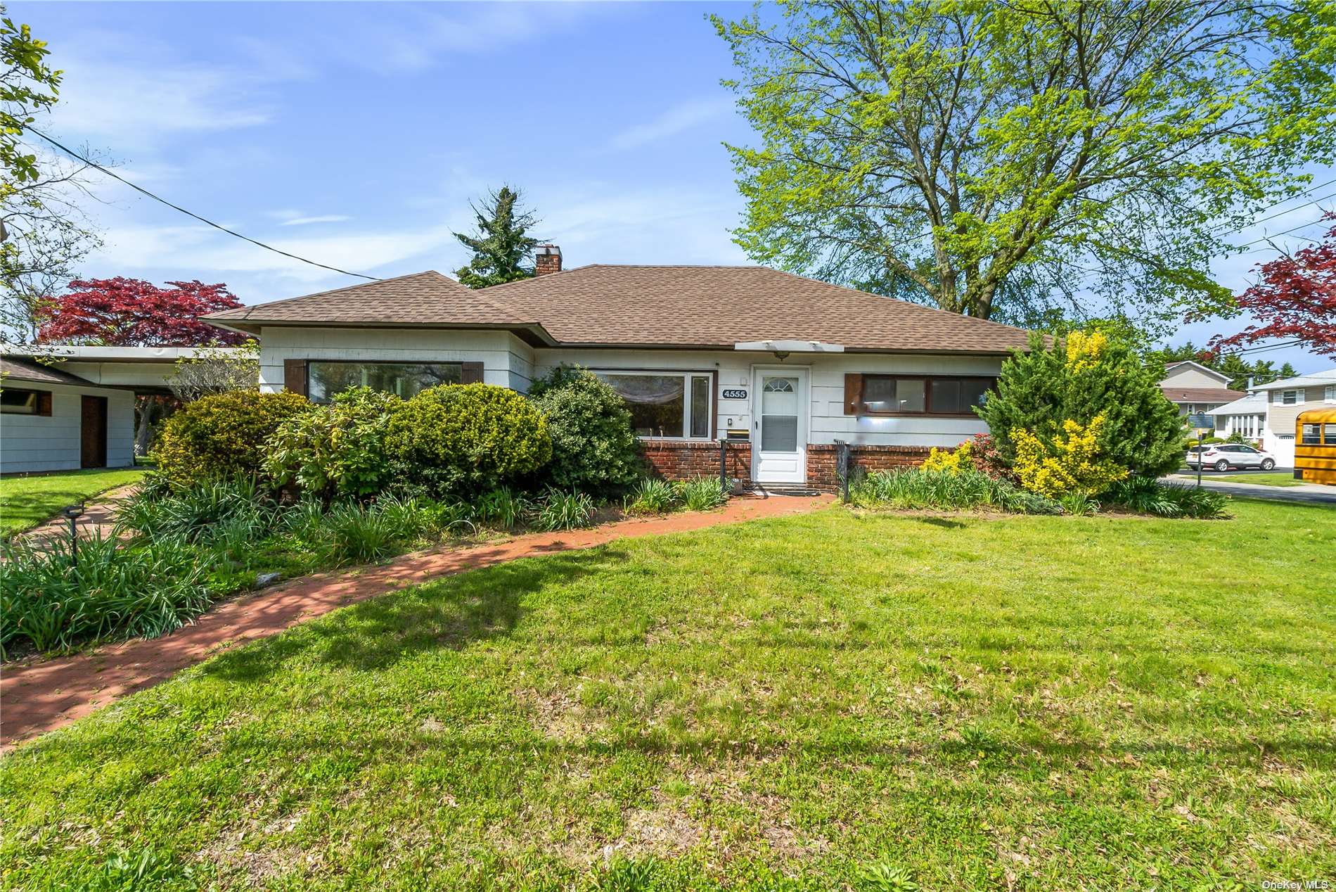 4555 Merrick Road Massapequa, NY 11758 - Photo 1 of 1 a front view of a house with garden