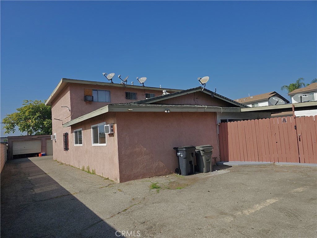 a view of a house with a garage and wall