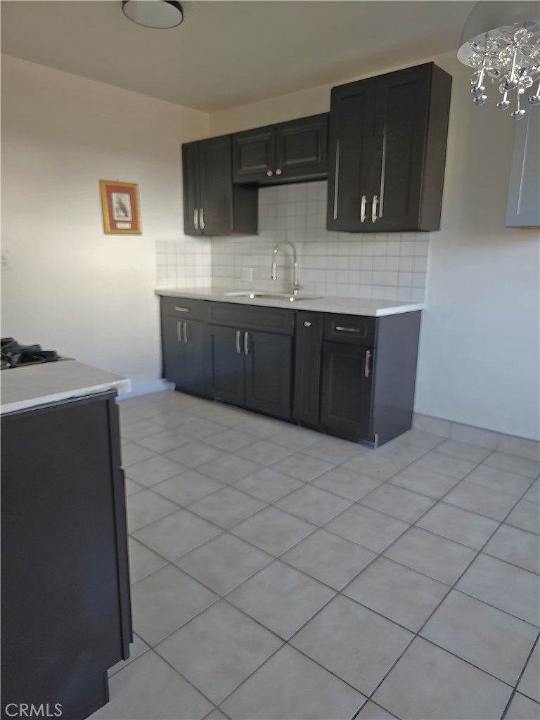 4133 Downing Avenue, Unit B Baldwin Park, CA 91706 - Photo 2 of 12 a kitchen with stainless steel appliances granite countertop a sink a stove a microwave a counter top and a stove