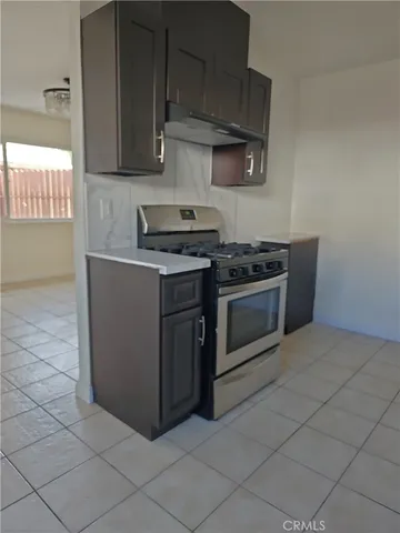 a kitchen with cabinets and a stove top oven