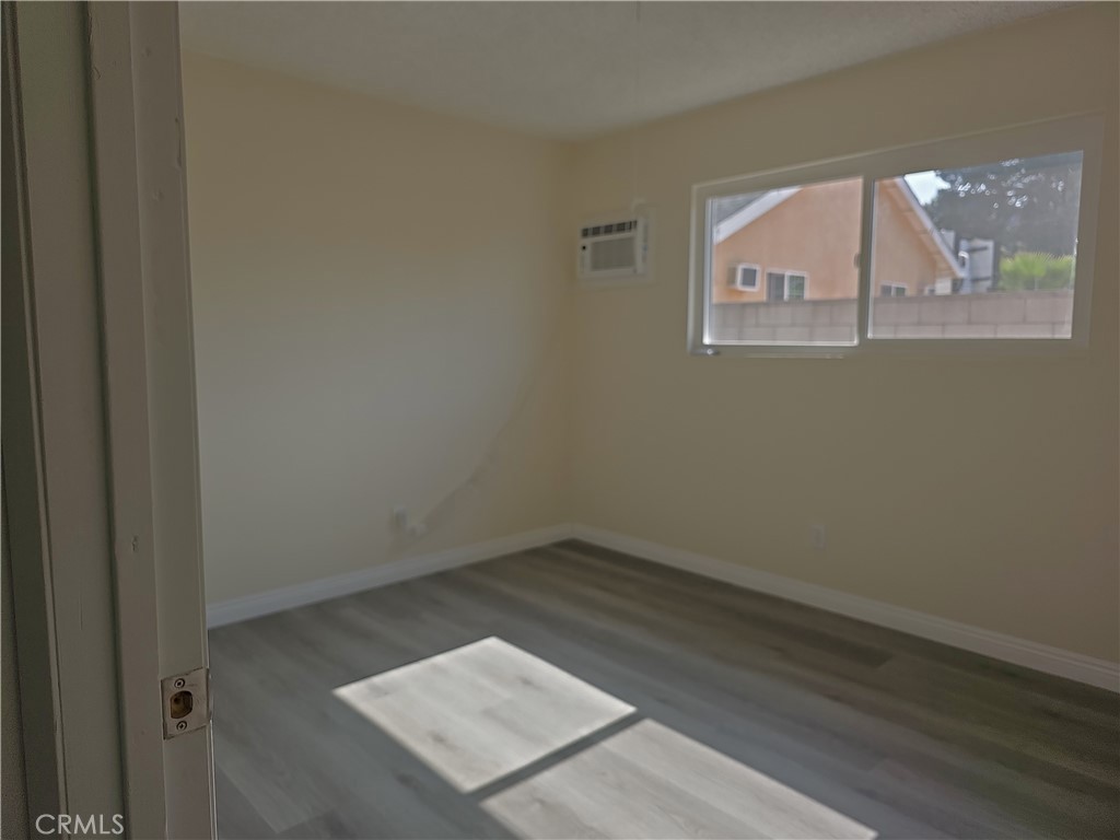 4133 Downing Avenue, Unit B Baldwin Park, CA 91706 - Photo 8 of 12 an empty room with wooden floor and windows