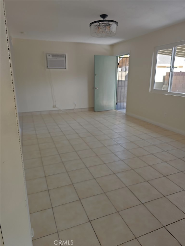 4133 Downing Avenue, Unit B Baldwin Park, CA 91706 - Photo 9 of 12 an empty room with chandelier fan and windows