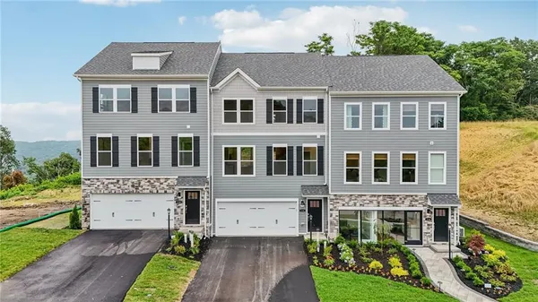 a aerial view of a brick house next to a yard