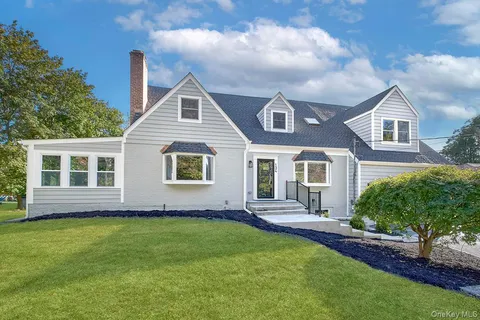 a front view of house with yard and green space