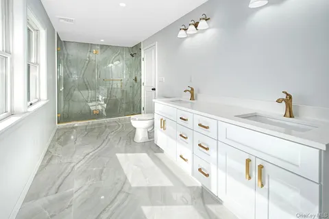 a bathroom with a bathtub shower sink and mirror